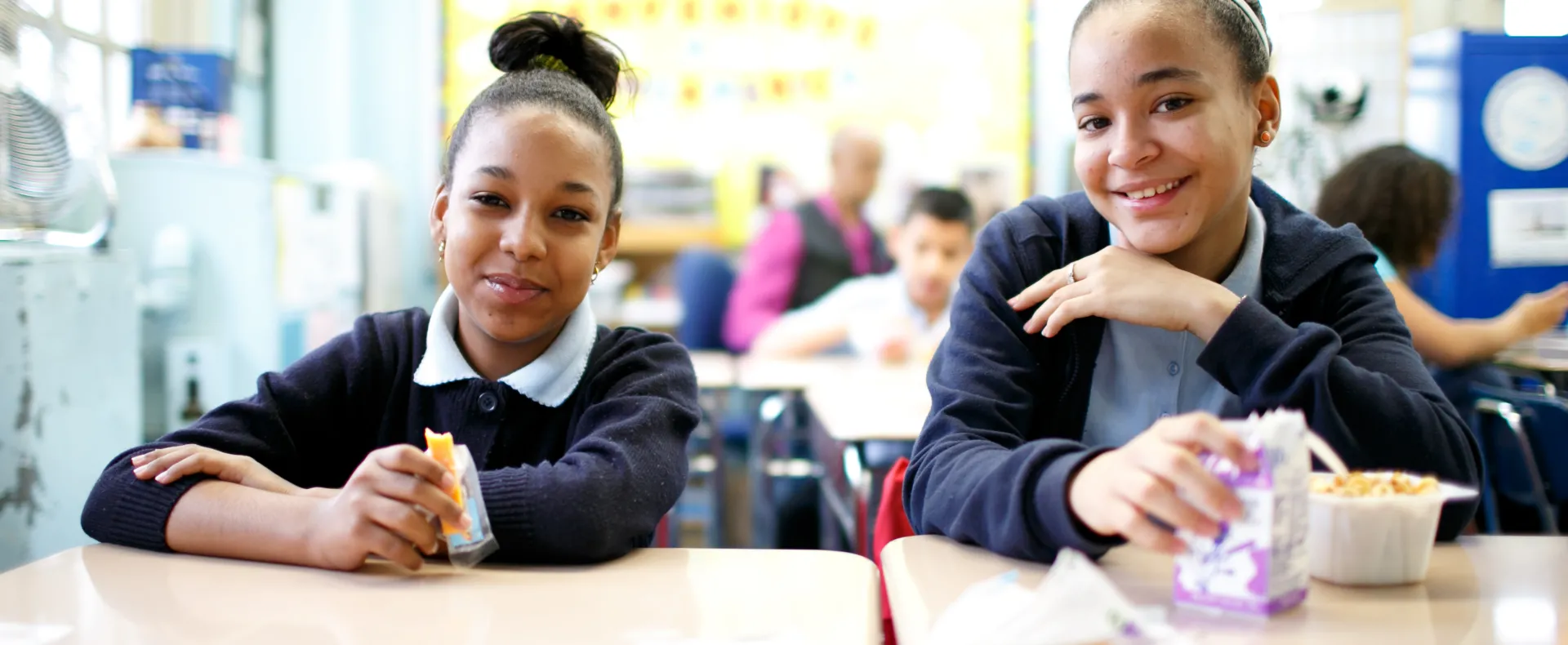Girls Eating School Breakfast in Classroom