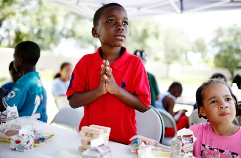 A little boy at a free summer meals site