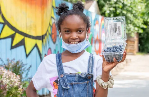 Little girl with mask outside