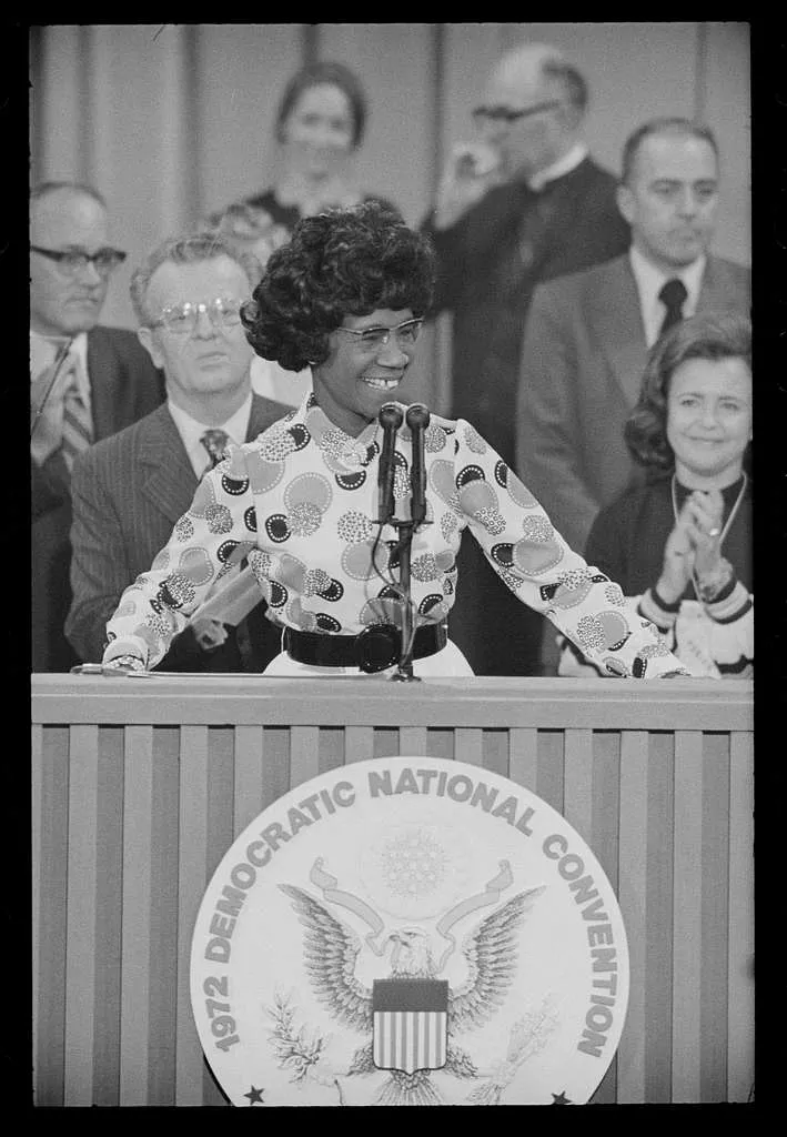 Black woman on a podium with Democratic National Convention sign