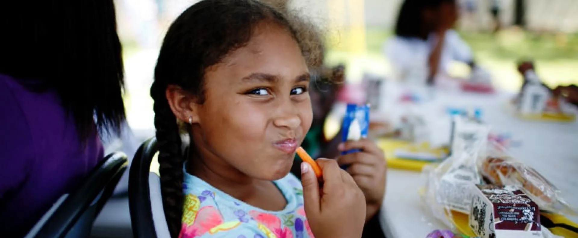 Girl eating a carrot stick