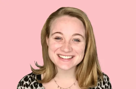 young white woman with blonde hair and smiling at the camera